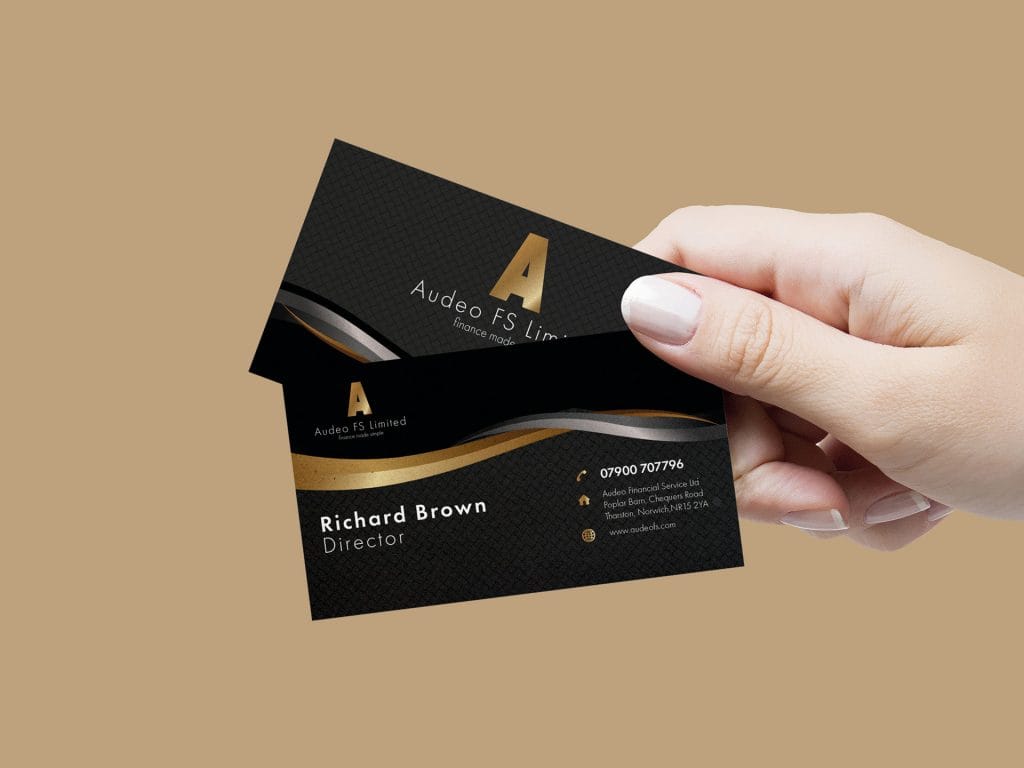Elegant black and gold foil Audeo FS business card held in hand