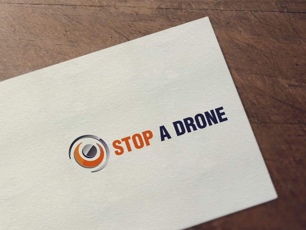 Stop a Drone logo embroidered on fabric in orange and navy blue