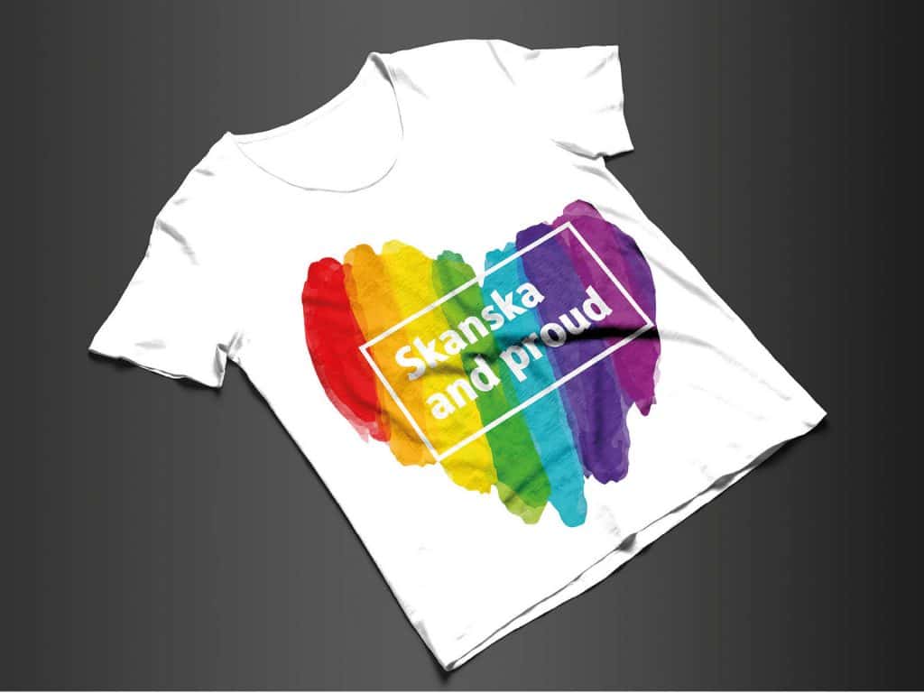 White Skanska Pride t-shirt with a rainbow heart and bold text celebrating inclusion and diversity.