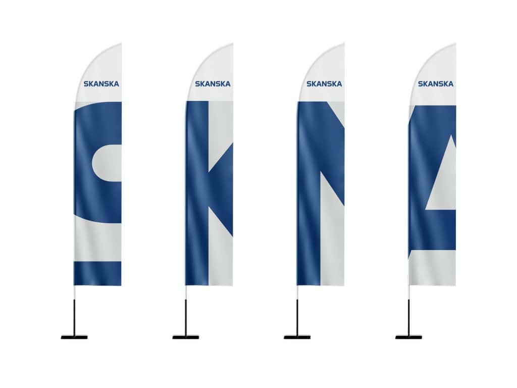 Mockup of Skanska branded vertical flags lined up with bold corporate lettering.