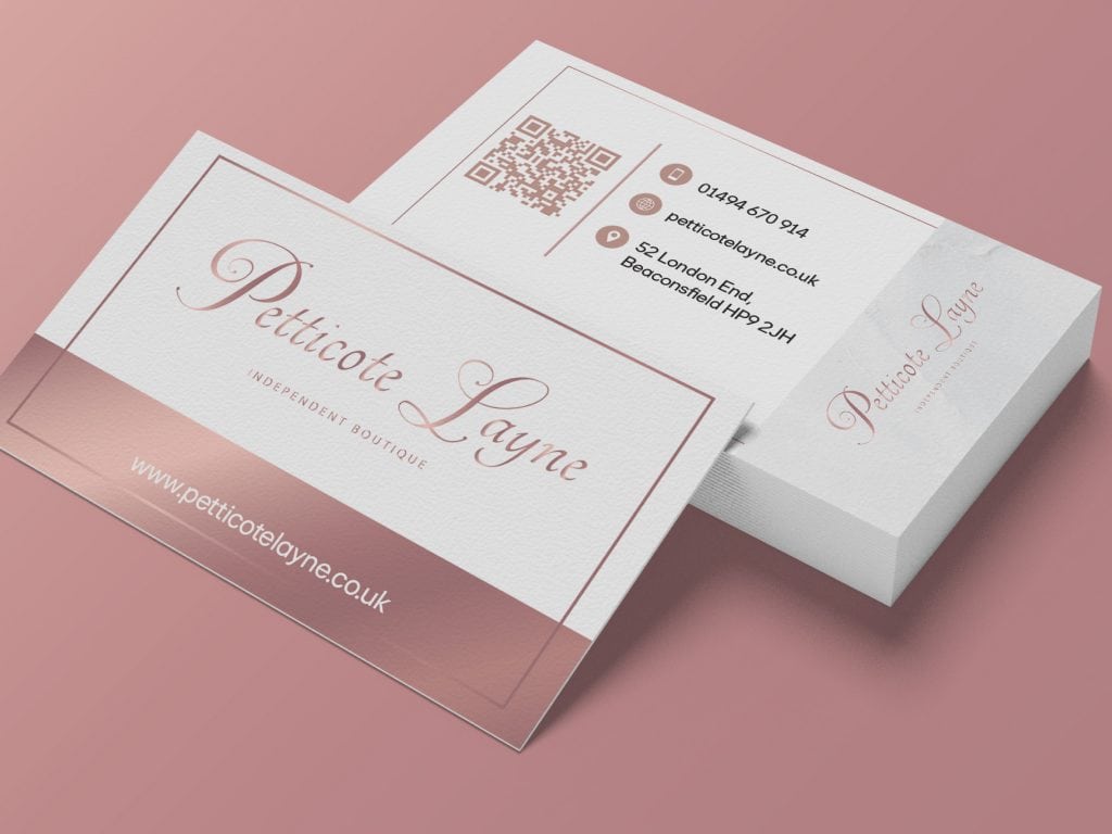 Rose gold and white business card design for Petticotte Layne Boutique, featuring elegant serif typography and soft luxury branding.